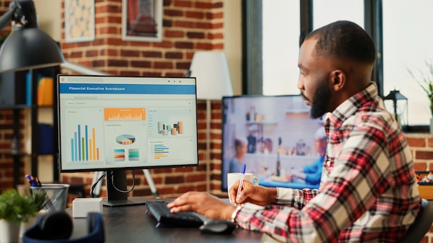 Teletrabalhador otimizando remotamente tarefas de negócios financeiros usando métricas estatísticas de desempenho. Funcionário profissional de contabilidade realizando análises remotamente enquanto trabalha em casa