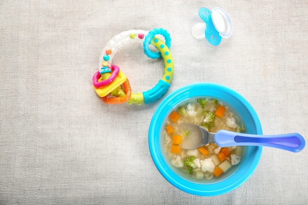 Teller mit leckerer Babysuppe auf dem Tisch