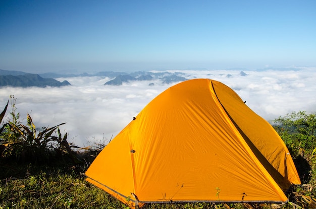 Tenda no pico da montanha contra o céu azul