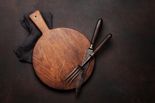 Tenedor y cuchillo vacíos de la tabla de cortar