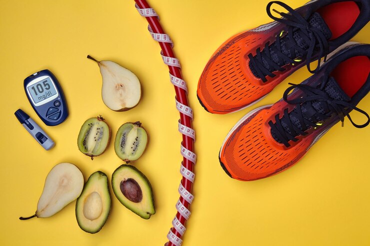 Foto tênis esportivo laranja, aro de ginástica embrulhado com uma fita métrica com um medidor, halteres, frutas e um medidor de glicose no sangue em um fundo amarelo. exercício e nutrição para um nível normal de açúcar no sangue
