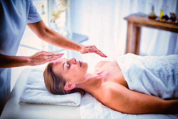 Terapeuta realizando reiki en mujer