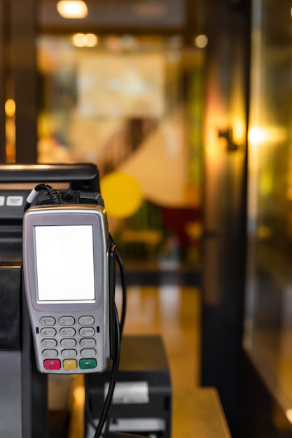 Terminal de pago con tarjeta a la entrada de un restaurante de comida rápida