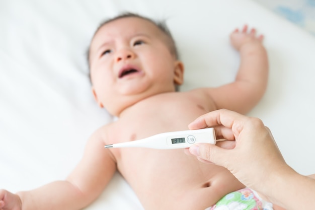 Termómetro digital para medir la temperatura del calor de un niño enfermo. Concepto de la fiebre del bebé