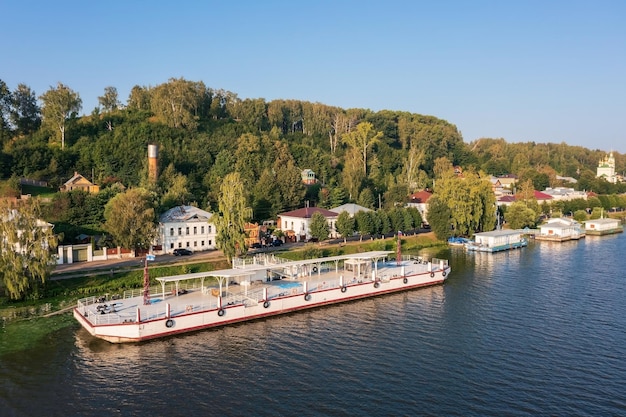 Terraplén de la ciudad a orillas del Volga con edificios en la ladera escondidos en un denso follaje Plyos Rusia