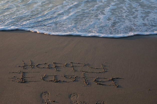 Text auf Sand am Strand