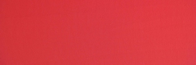 Textil rojo brillante unicolor como fondo Cerca de tejido textil rojo