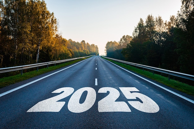 Texto 2025 escrito en la carretera en el medio de la carretera de asfalto con al atardecer Nuevo año 2025 o concepto directo hacia adelante Concepto de planificación objetivo desafío resolución de nuevo año