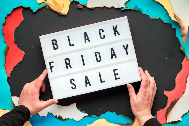 Texto de lightbox black friday sale com as mãos em papel queimado