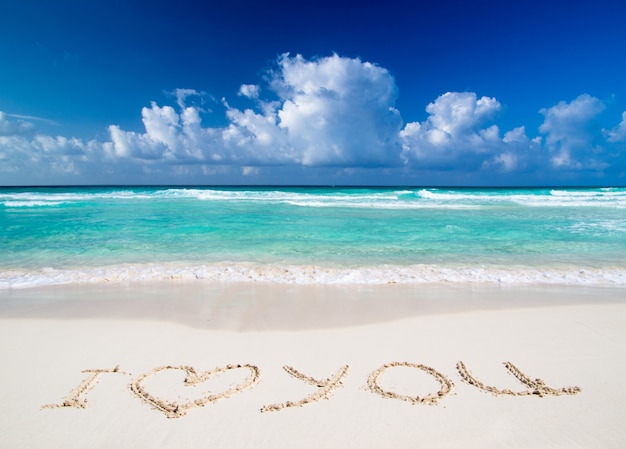 Texto "eu te amo" texto escrito na areia na praia