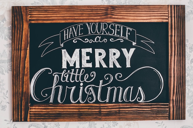 Texto de feliz Navidad en un marco de madera