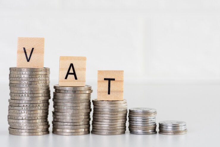 Foto texto del iva en pilas de monedas. concepto de dinero financiero y de ahorro.