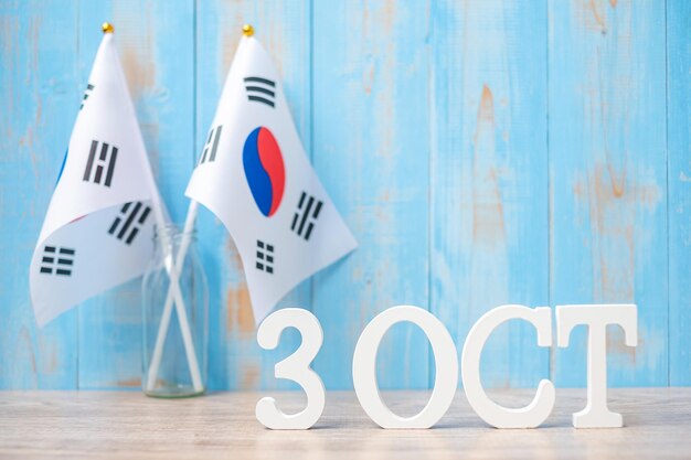 Foto texto de madera del 3 de octubre con banderas de la república de corea día de la fundación nacional gaecheonjeol fiesta pública día de la nación y conceptos de celebración felices