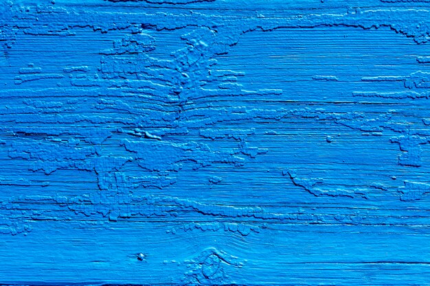 Textur. Alte bemalte Wand des Hauses. Alter hölzerner Zaun Blaue Farbe