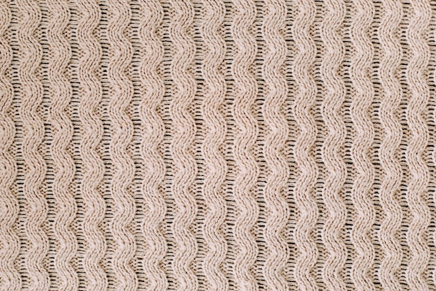 Textur aus gestricktem Wollstoff für Tapeten und einen abstrakten Hintergrund