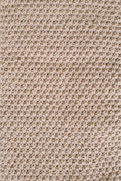 Textur aus gestricktem Wollstoff für Tapeten und einen abstrakten Hintergrund