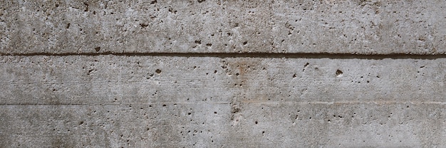 Textur aus grauem Beton mit Kartonabdrücken