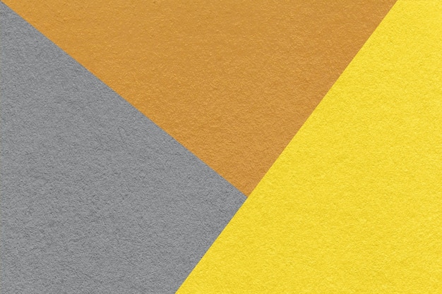 Textur aus grauem, gelbem und braunem Farbpapierhintergrundmakro Struktur des abstrakten Vintage-Kartons