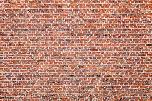 Foto textur der alten dunkelbraunen blöcke, rote backsteinmauer.