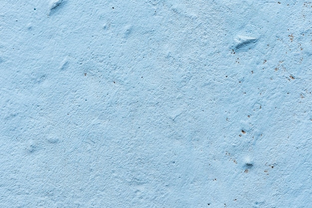 Textur der hellblauen Betonwand Blaue raue Wand Die Oberfläche ist mit einem Aerosolspray lackiert