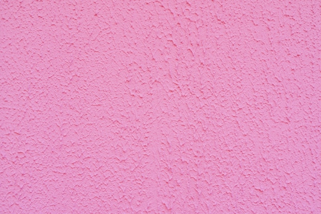 Textur des rauen rosa Putzes. Architektonischer abstrakter Hintergrund.