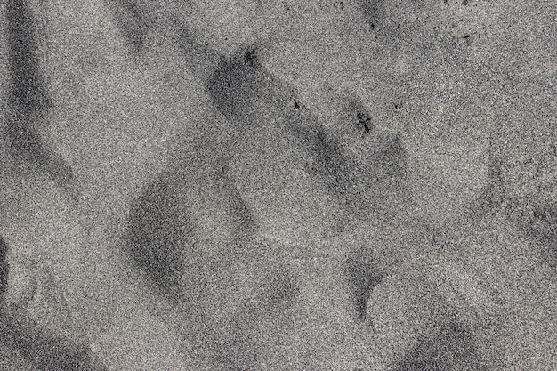 Textur des schwarzen magnetischen Sandes für den Hintergrund