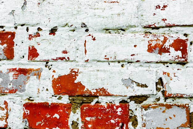 Foto textur einer backsteinmauer mit rissen und kratzern, die als hintergrund verwendet werden können