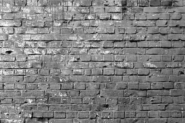 Foto textur einer backsteinmauer mit rissen und kratzern, die als hintergrund verwendet werden können