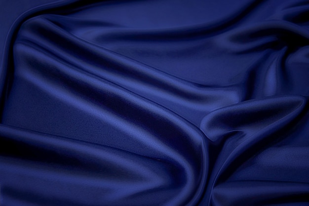 Textur, Hintergrund, Muster. Textur aus blauem Seidenstoff. Schöner blauer weicher Seidenstoff.