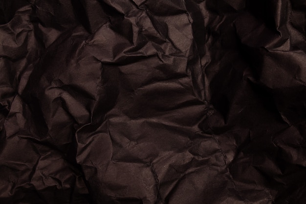 Textur oder Hintergrund von detailliertem, schwarz getöntem, zerknittertem Papier