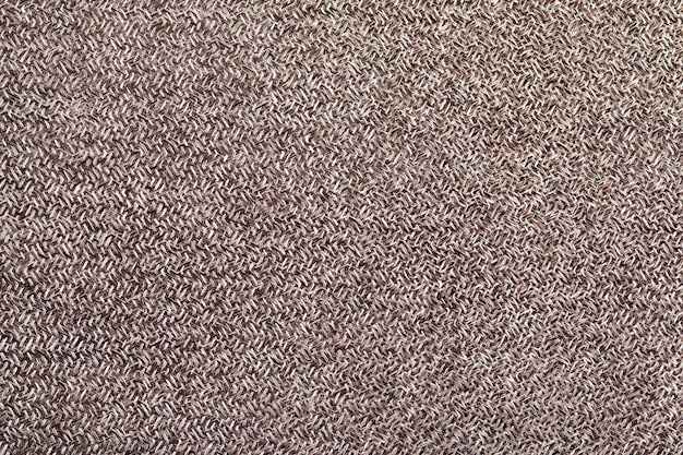 Textur und Muster des natürlichen beigefarbenen Wollpalastes Hintergrund des gewebten Materials