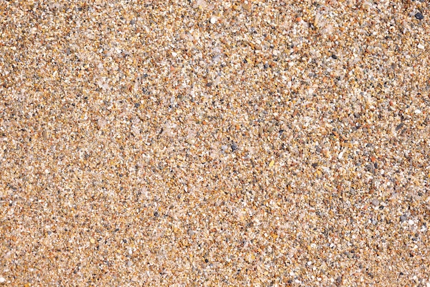 Textur von Steinen und Sand am Strand