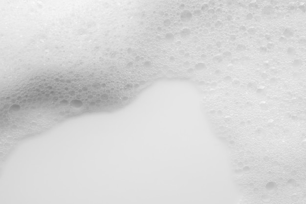 Foto textura abstrata de bolhas de espuma de sabão branco em fundo branco