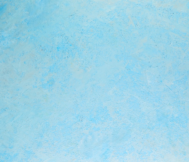 Textura abstrata de fundo de gesso áspero com salpicos brancos de azul.