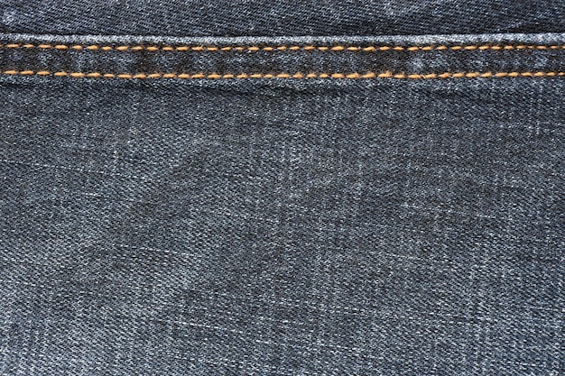 Textura abstrata detalhada de pano de denim azul escuro Imagem de fundo de tecido de calças de denim usado velho