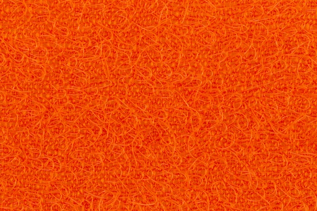 Textura abstrata dos panos de superfície laranja para lavar pratos close-up macro