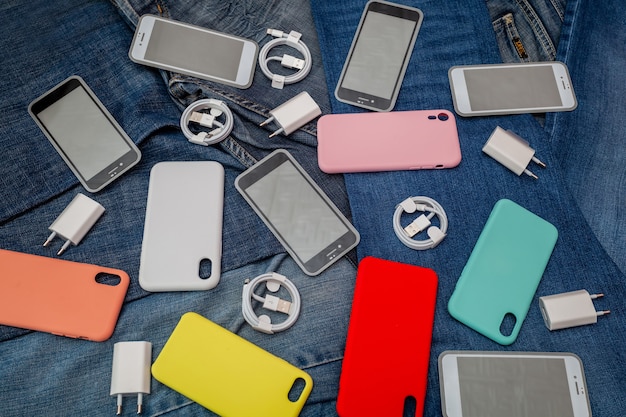 Foto textura de accesorios para teléfonos móviles sobre un fondo de mezclilla