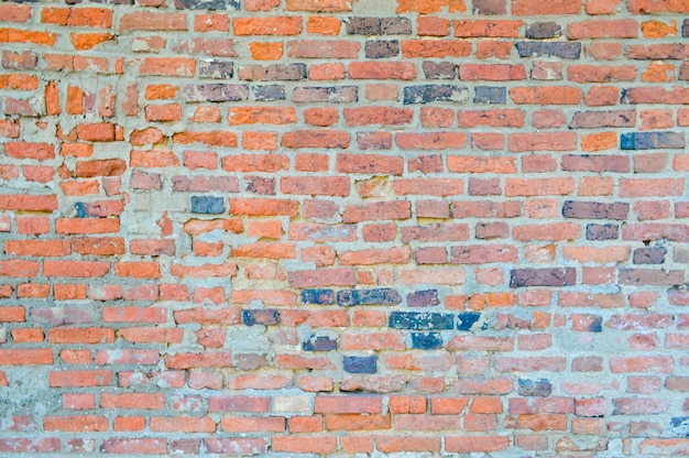 Foto la textura de la antigua piedra medieval antigua resistente que pela la pared rayada de forma rectangular