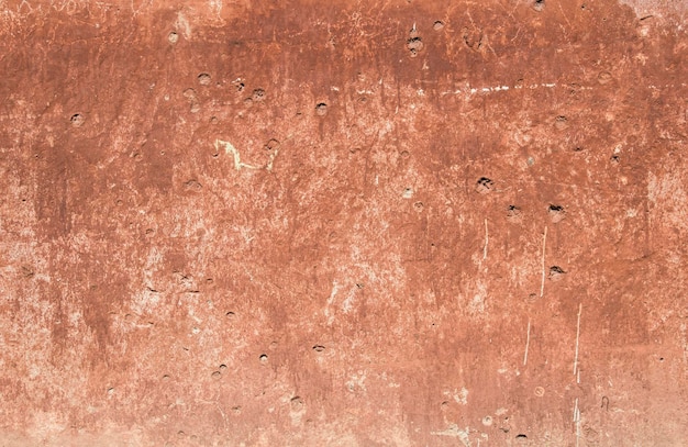 Textura de un antiguo muro de hormigón rojo