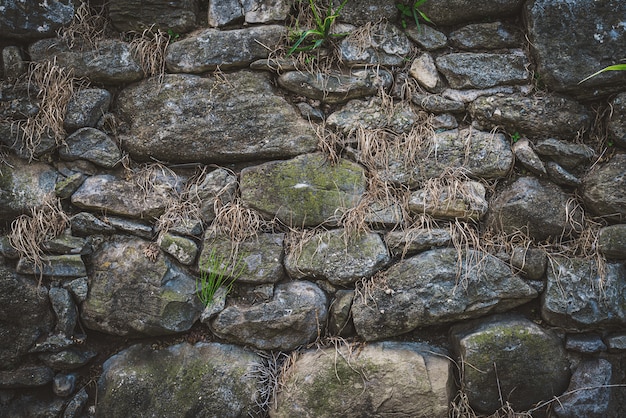 Foto textura de un antiguo muro de piedra natural