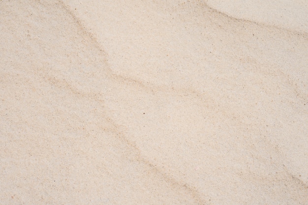 Textura de arena de primer plano en la playa en sol de verano