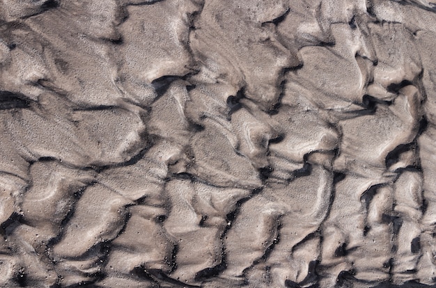 Foto textura de arena superficie arenosa curvada formada por agua