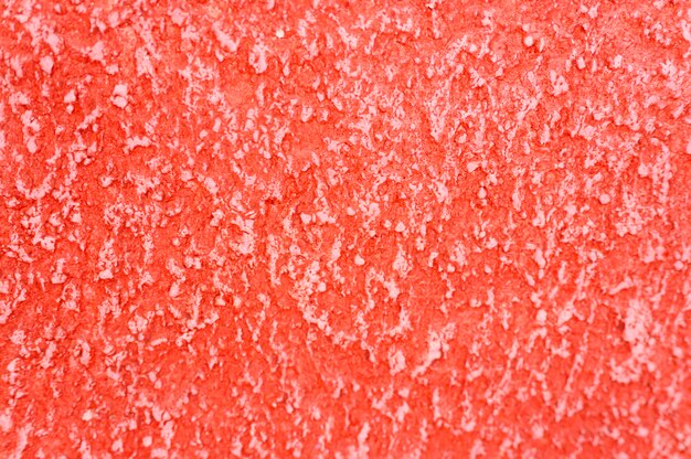 Textura áspera del fondo rojo decorativo abstracto de la pared del yeso.