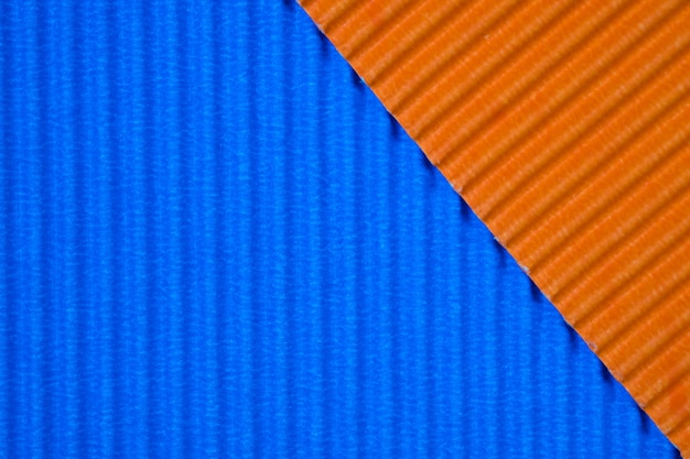 Textura azul y anaranjada del papel acanalado, uso para el fondo. Color vivo con espacio vacío para agregar texto u objeto.