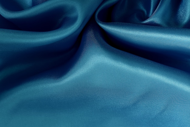 Textura azul de pano da tela para o trabalho de arte do fundo e do projeto, teste padrão bonito da seda ou linho.