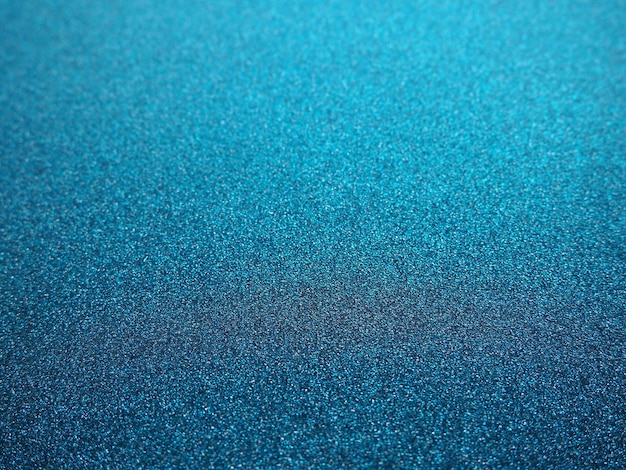 Textura azul profunda de papel áspero ou papelão desfocado brilhos de bokeh e fundo azul festivo brilhante