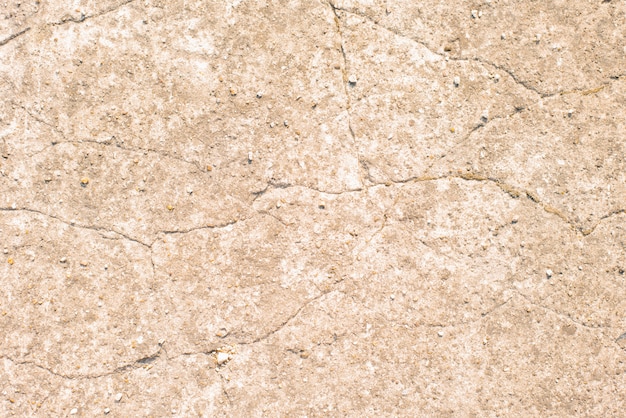 Textura beige de pared agrietada con yeso