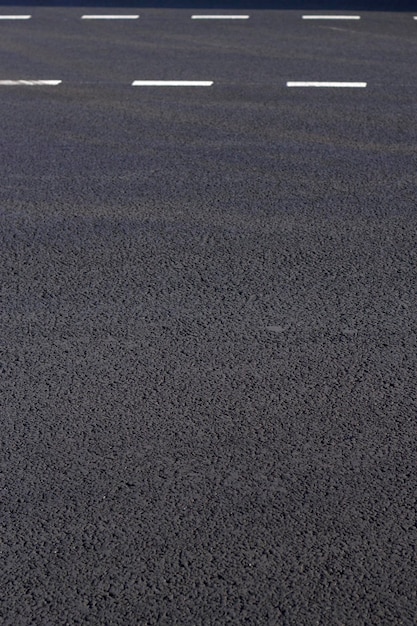 Foto textura de la carretera fondo vertical con líneas blancas