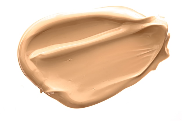 Textura cosmética de belleza beige aislada sobre fondo blanco manchado maquillaje emulsión crema frotis o fo ...