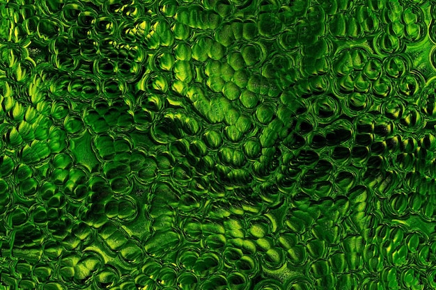 Foto la textura de cuero de cocodrilo dorado verde es abstracta, la piel de serpiente, el dinosaurio, el dragón, el reptil, el estilo retro, el antiguo.